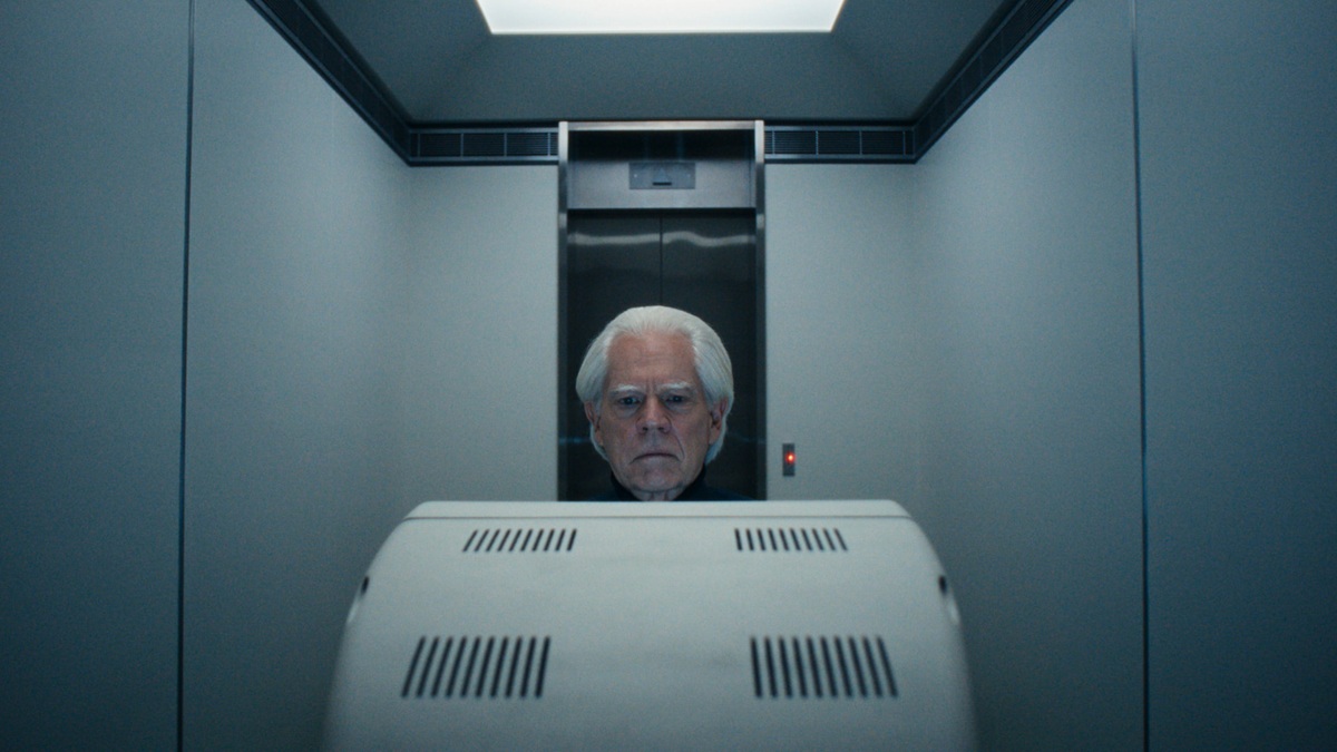 Severance - Jame Eagan sits in front of a white Lumon computer screenstaring at it